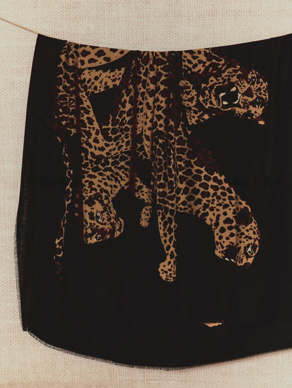 Extra-large black wool shawl displayed vertically with a bold golden-brown leopard illustration