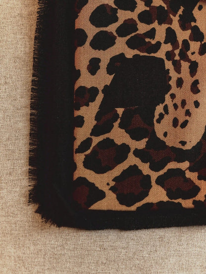 Detailed leopard face and spotted pattern on an oversized black wool scarf