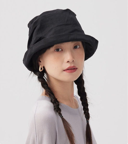 Black rolled brim linen bucket hat for women with natural crinkled texture and casual styling