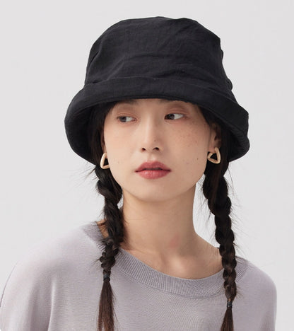 Front view of black crinkled linen bucket hat with short brim and relaxed everyday look