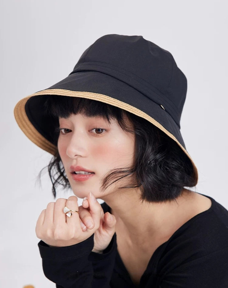 black foldable bucket sun hat with wide brim styled for outdoor travel and beach wear