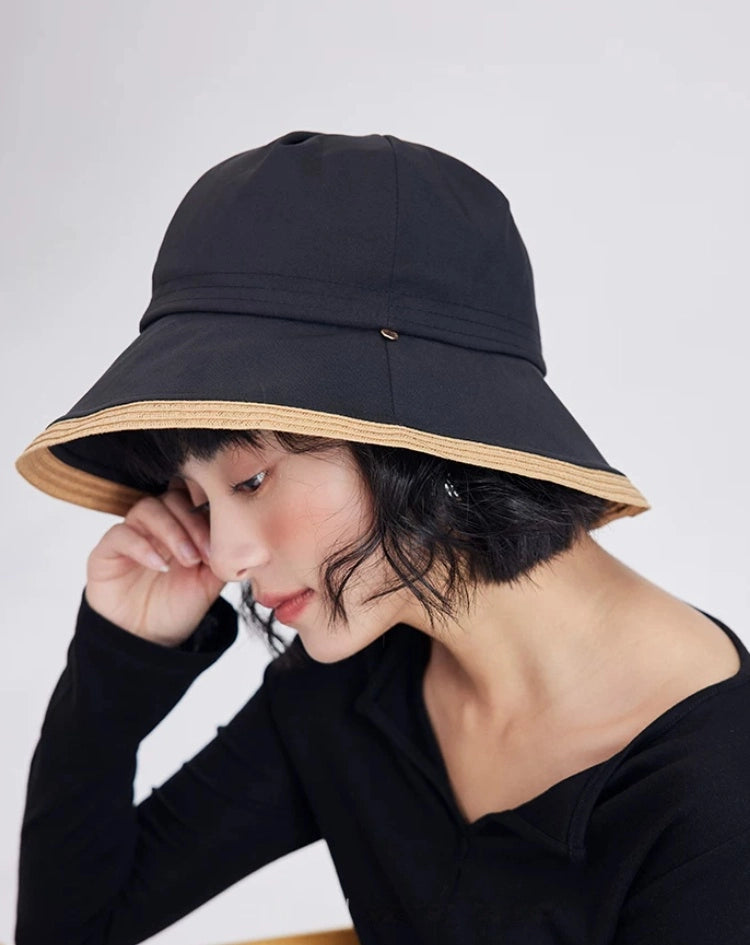 model styling a black wide brim sun hat with minimalist casual summer outfit