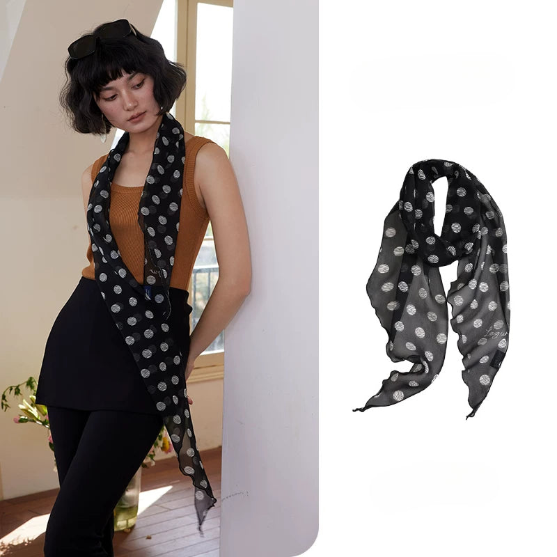 Black polka dot skinny silk scarf in 100% mulberry silk, styled as a neck scarf with elegant everyday outfit