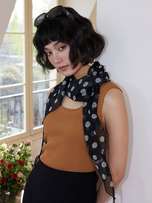 Black polka dot mulberry silk twilly scarf worn as a long neck ribbon with soft georgette drape