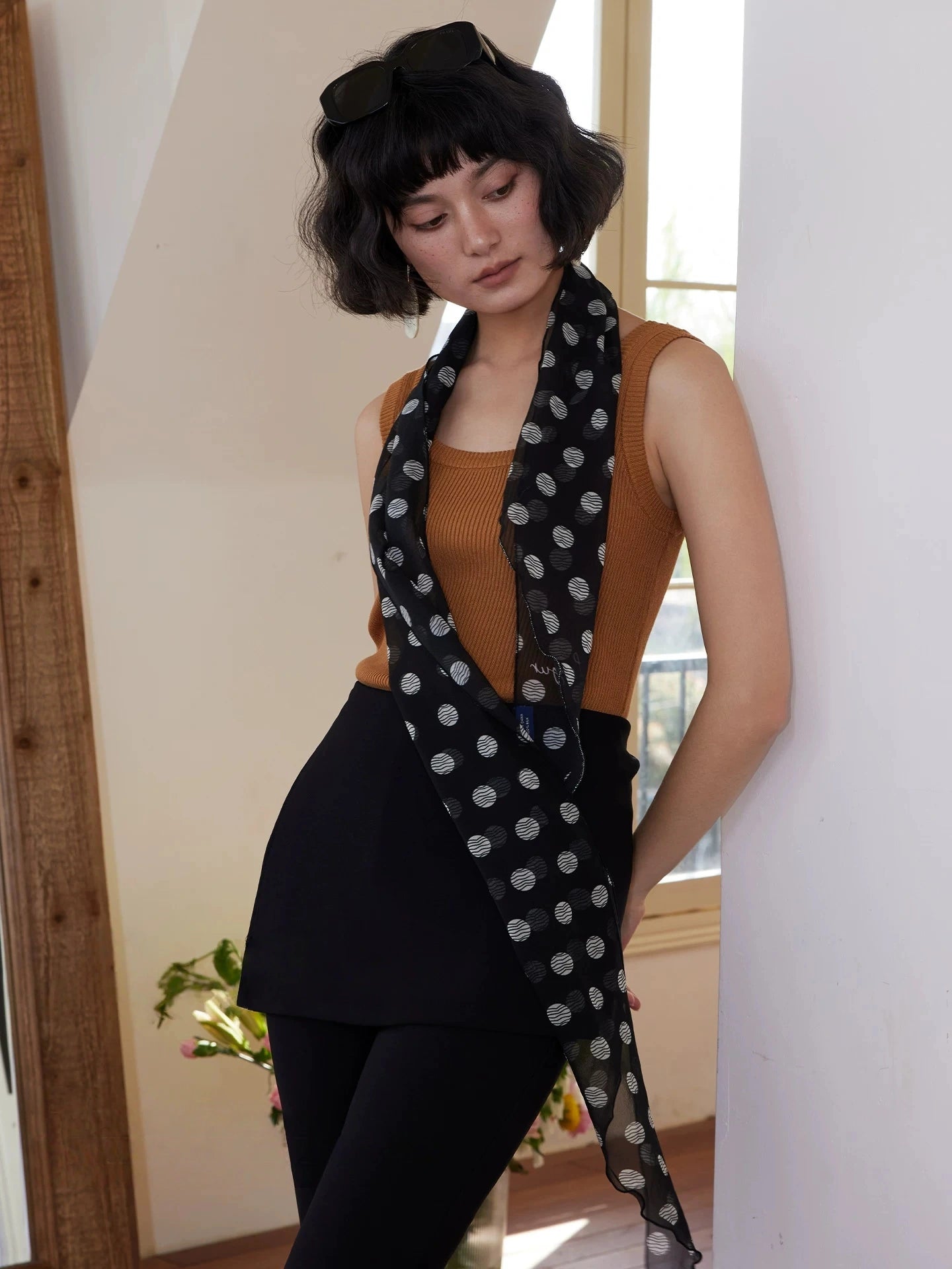 Classic black polka dot silk ribbon scarf for women, styled as a long skinny neck scarf