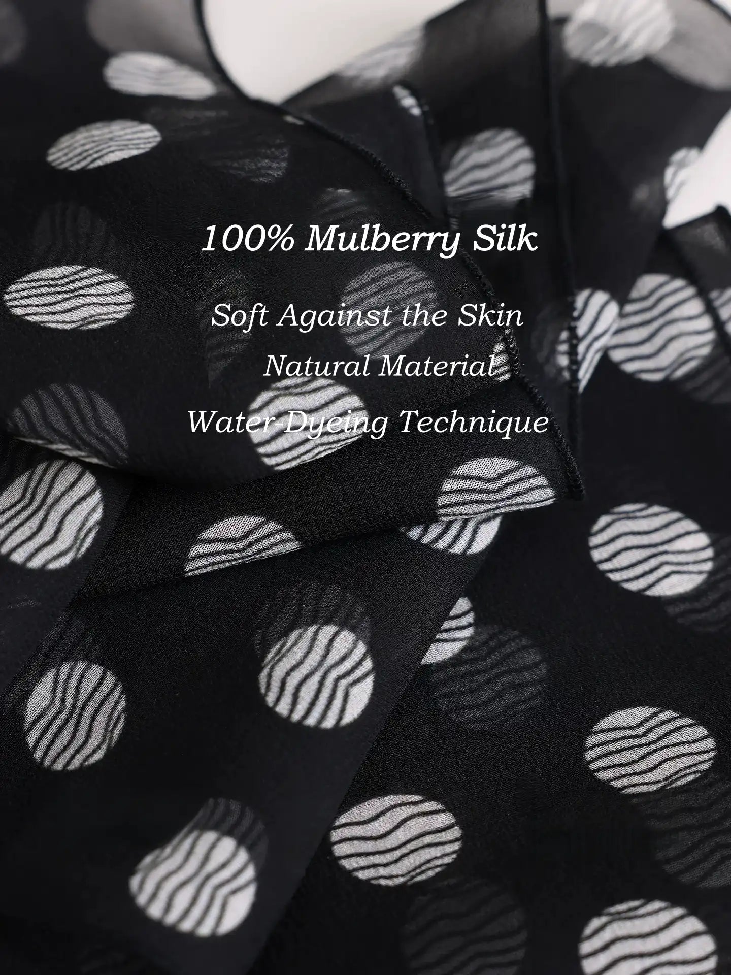 Close-up of black polka dot 100% mulberry silk georgette scarf with soft natural texture