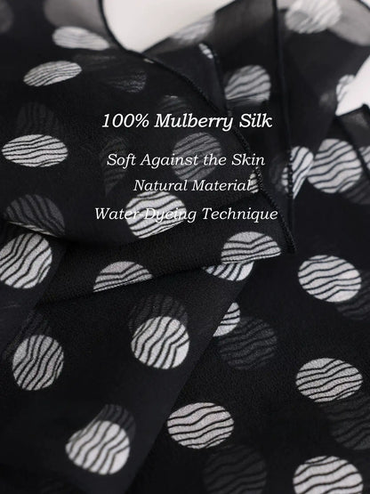 Close-up of black polka dot 100% mulberry silk georgette scarf with soft natural texture