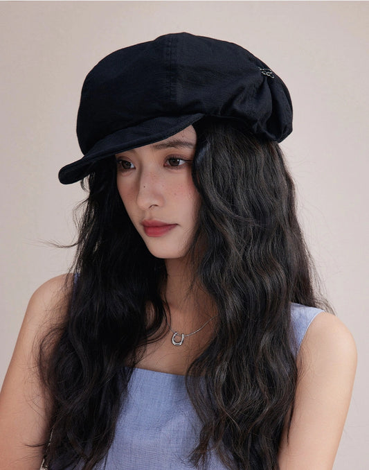 Model wearing black slouchy cotton beret hat, a lightweight cotton beret for effortless streetwear style