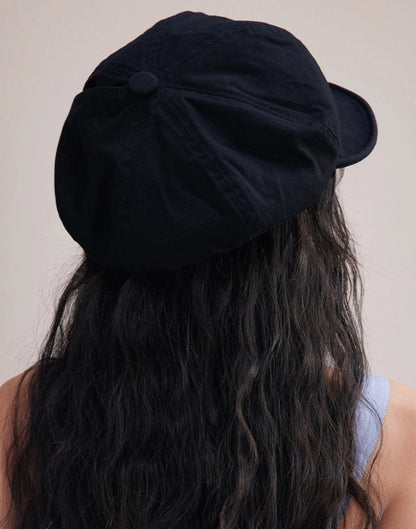 Back view of black slouchy cotton beret cap with soft gathered shape and relaxed casual silhouette