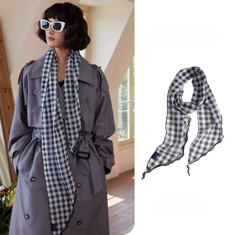 Black and white gingham skinny silk scarf in 100% mulberry silk, styled as a long neck scarf with grey trench coat
