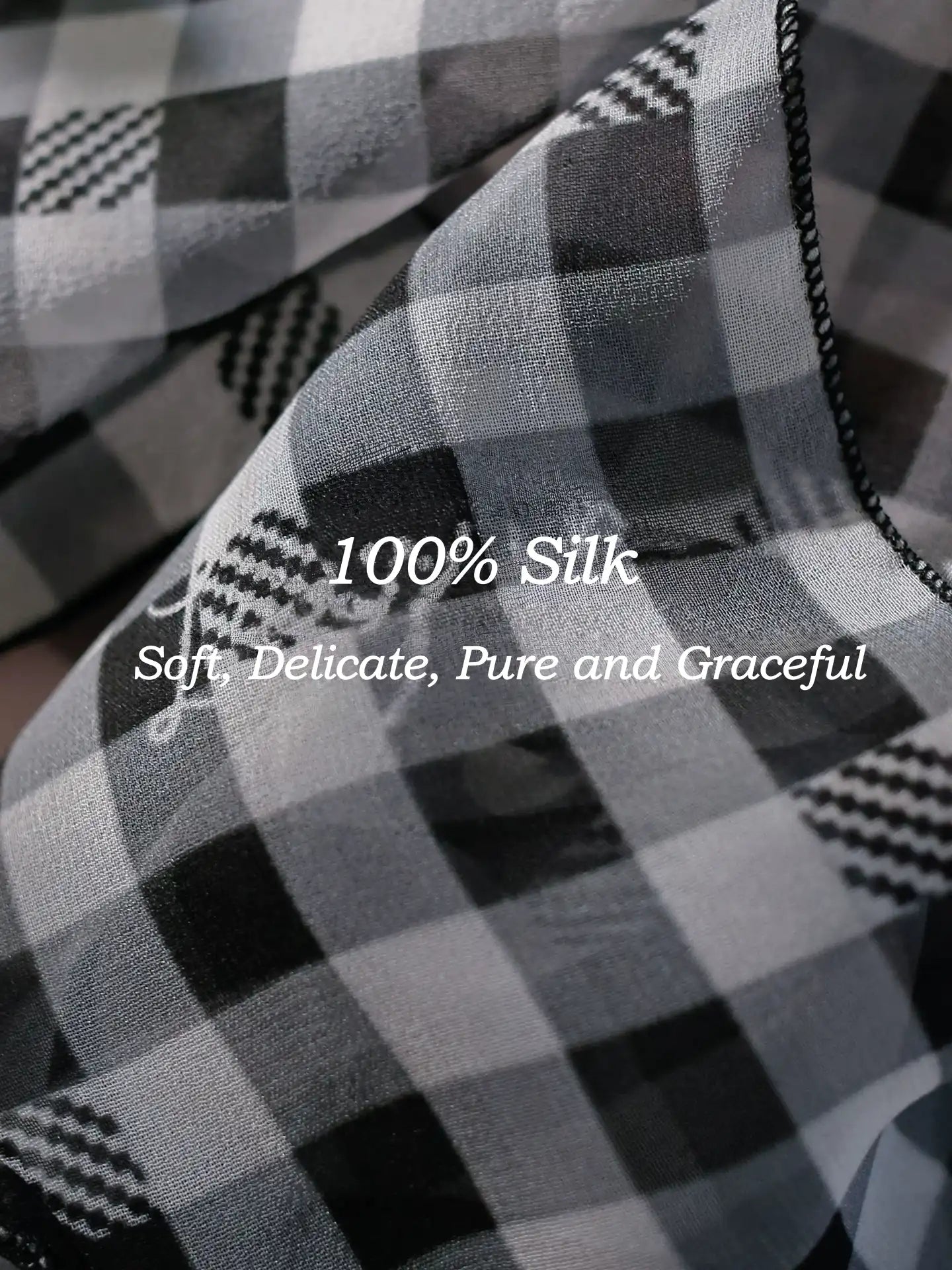 Close-up of black white gingham 100% mulberry silk scarf with smooth lightweight texture