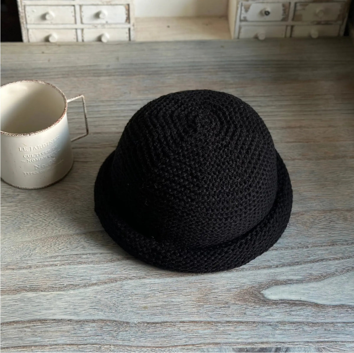 Black wool blend dome beanie with a textured knit crown and rolled edge shown at an angle