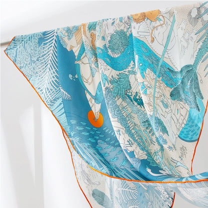 Close-up of blue animal kingdom silk scarf with exotic wildlife print and soft drapable silk finish.
