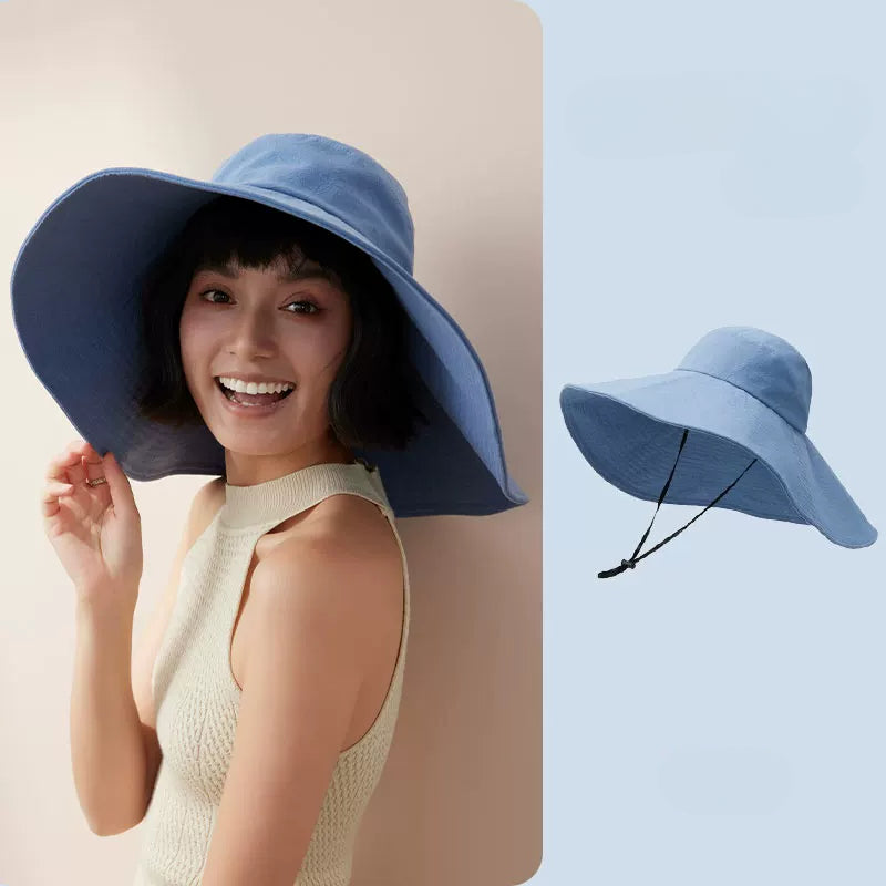 Woman wearing blue cotton oversized wide brim sun hat with wind cord, shown with product view