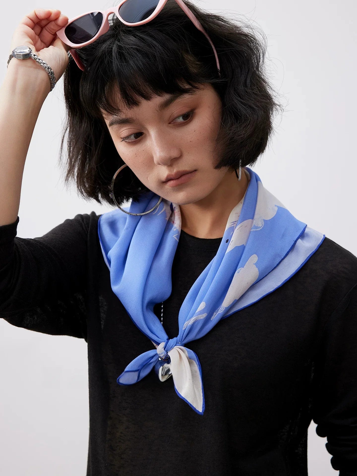 Model wearing blue dalmatian print mulberry silk scarf as a stylish silk neckerchief