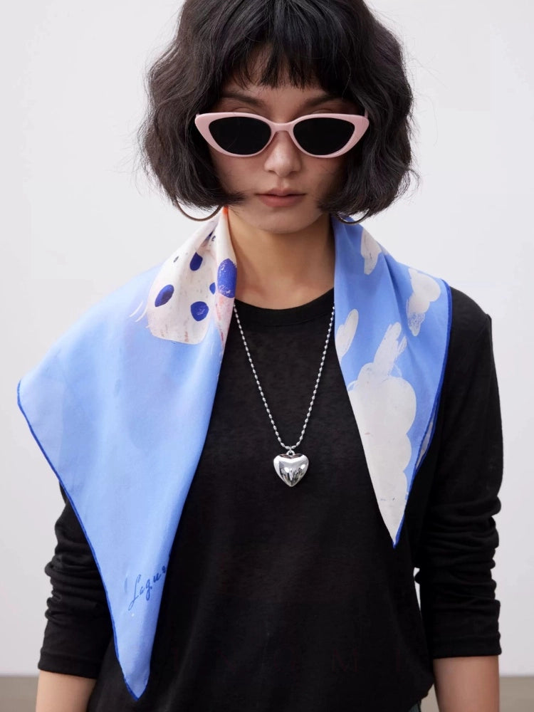Blue dalmatian printed real silk square scarf draped over shoulders for modern casual styling