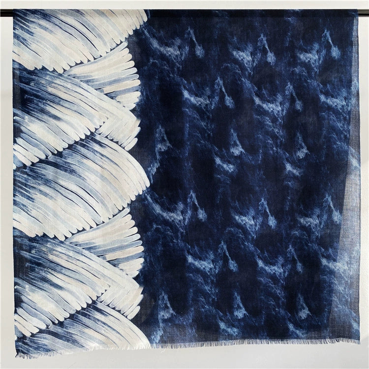 Blue galaxy and ocean wave 100% wool scarf displayed flat with a navy, indigo and ivory pattern
