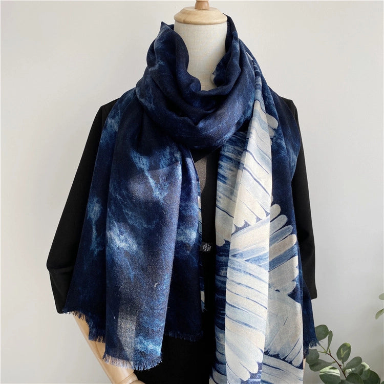 Navy ocean wave wool scarf loosely wrapped with the ivory patterned edge hanging in front