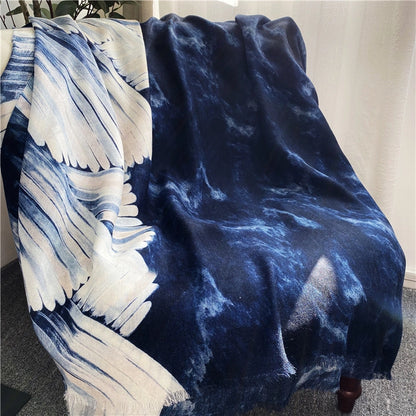 Blue ocean wave printed wool scarf draped over a chair to display the navy and ivory artwork