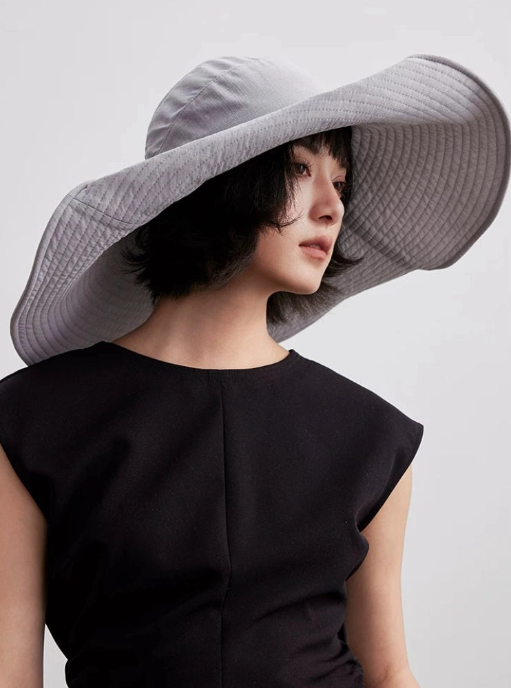 Blue gray foldable sun hat with wide brim, memory wire edge, and refined travel-ready design