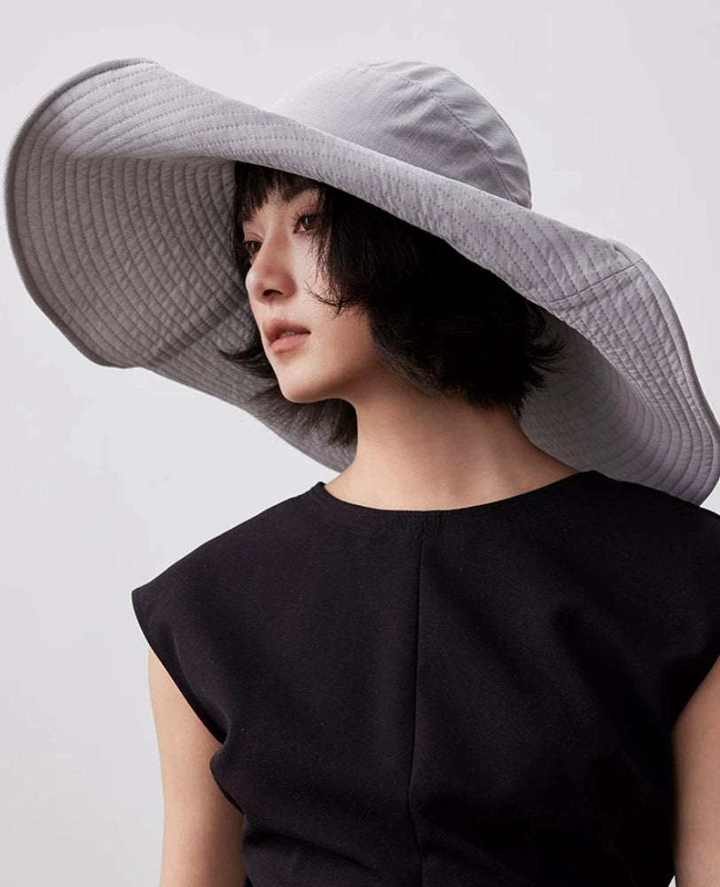 Close-up of blue gray packable wide brim sun hat with sculptural brim and UV protection design