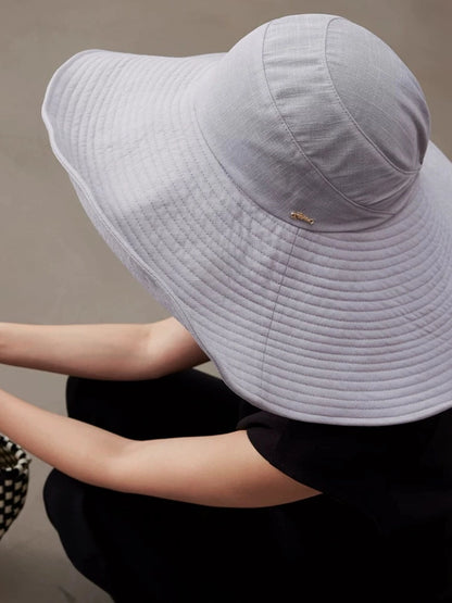 Back view of blue gray UPF 100 roll-up sun hat with wide brim and protective summer coverage