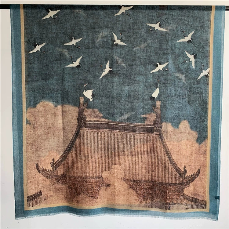 Blue Oriental crane and pavilion scarf in 100% fine wool, shown flat with the full oversized landscape motif