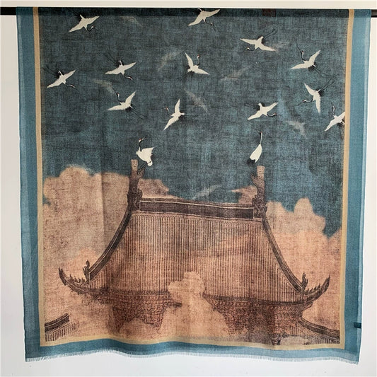 Blue Oriental crane and pavilion scarf in 100% fine wool, shown flat with the full oversized landscape motif