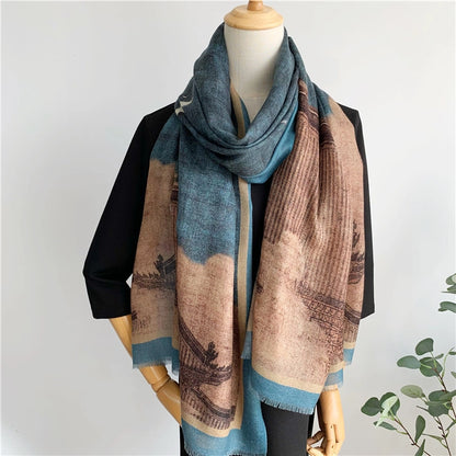 Front view of blue crane and pavilion fine wool scarf worn long over a black dress