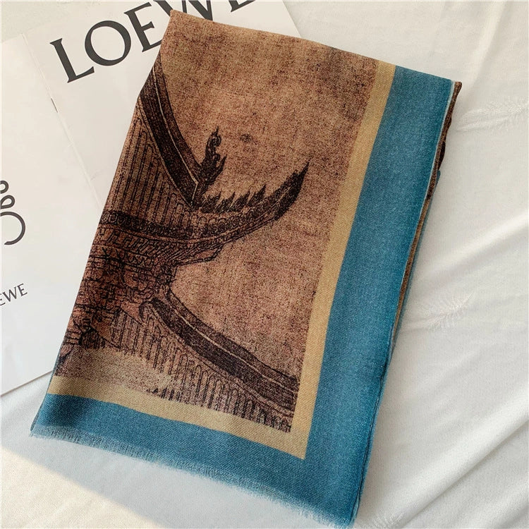 Folded blue Oriental wool scarf with a close-up pavilion print and turquoise border