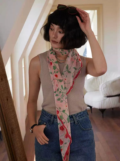Romantic botanical long silk scarf styled loosely over a neutral sleeveless top