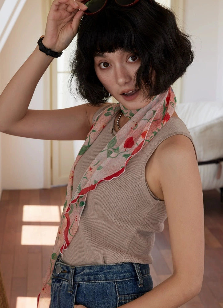 Sheer blush pink silk scarf with botanical print styled as an elegant neck accessory