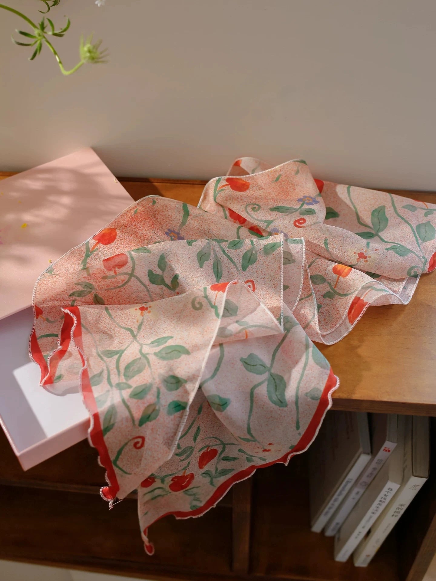 Blush pink botanical silk scarf displayed flat showing sheer lightweight texture