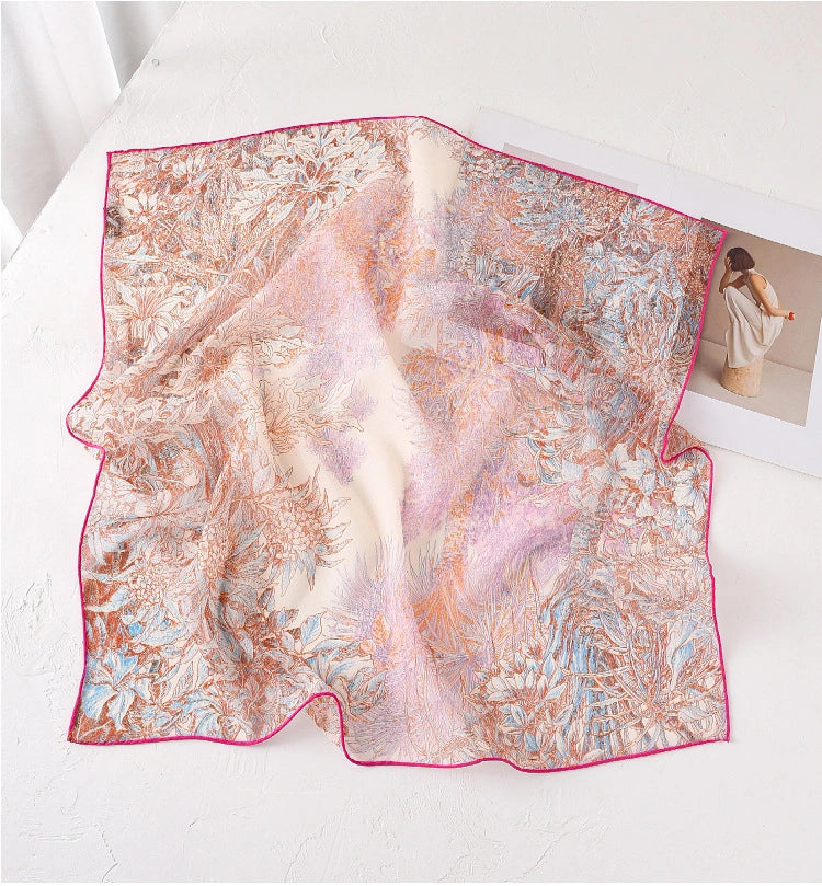 Pink botanical print mulberry silk square scarf displayed flat with sheer lightweight texture