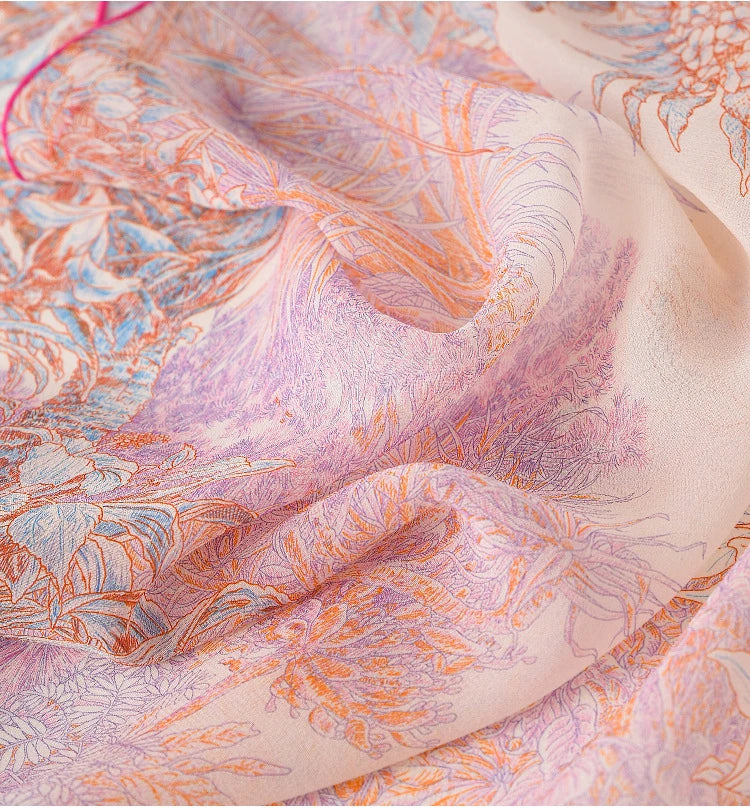 Close-up of pink botanical silk scarf showing soft floral details and smooth silk sheen