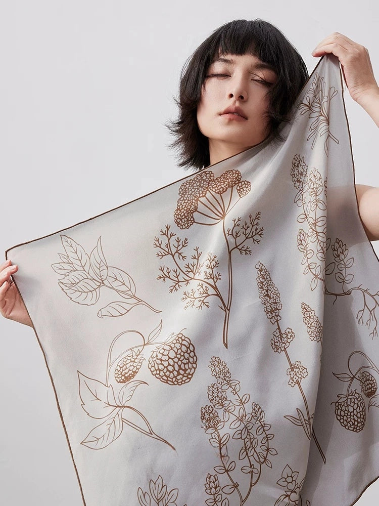 Elegant botanical silk square scarf with soft neutral floral print, crafted from 100% mulberry silk