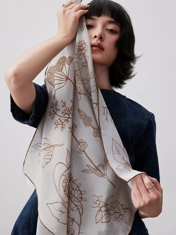 Neutral botanical silk scarf made from 100% mulberry silk, styled as a graceful fashion accessory for women