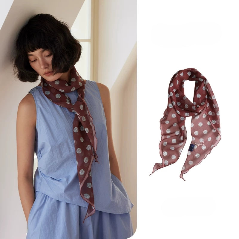 Brown polka dot skinny silk scarf in 100% mulberry silk, styled as a long neck scarf with light blue dress