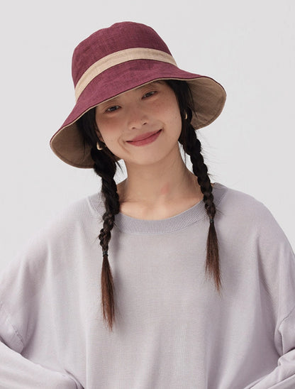 Model wearing a burgundy beige reversible ramie cotton bucket hat with a wide brim