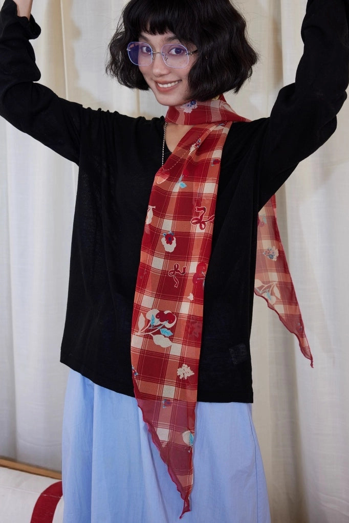 Retro red plaid skinny silk scarf styled around the neck, featuring cherry details and lightweight mulberry silk fabric