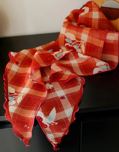 Close-up of burgundy cherry plaid skinny silk scarf, showing soft mulberry silk texture and retro tartan print