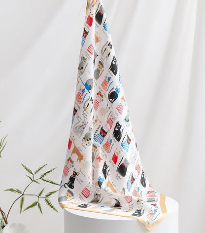 Lightweight cat silk scarf draped softly, featuring an artistic cartoon cat print on mulberry silk.