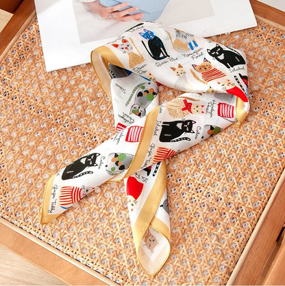 Cat print silk scarf in 100% mulberry silk, displayed with soft folds and an elegant ivory border.