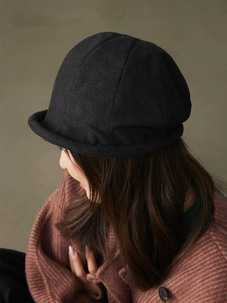 Back view of a charcoal gray vintage cloche hat showing the paneled dome crown and rolled edge