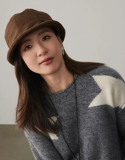 Woman wearing a coffee brown felt cloche hat with a rolled brim and relaxed autumn outfit