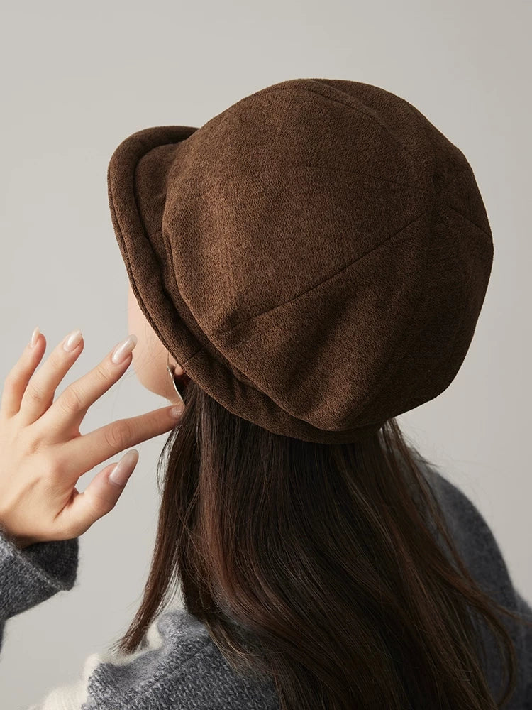 Back view of a coffee brown cloche hat showing the rounded paneled crown and curved edge