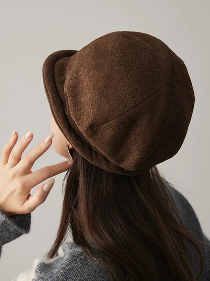 Back view of a coffee brown cloche hat showing the rounded paneled crown and curved edge