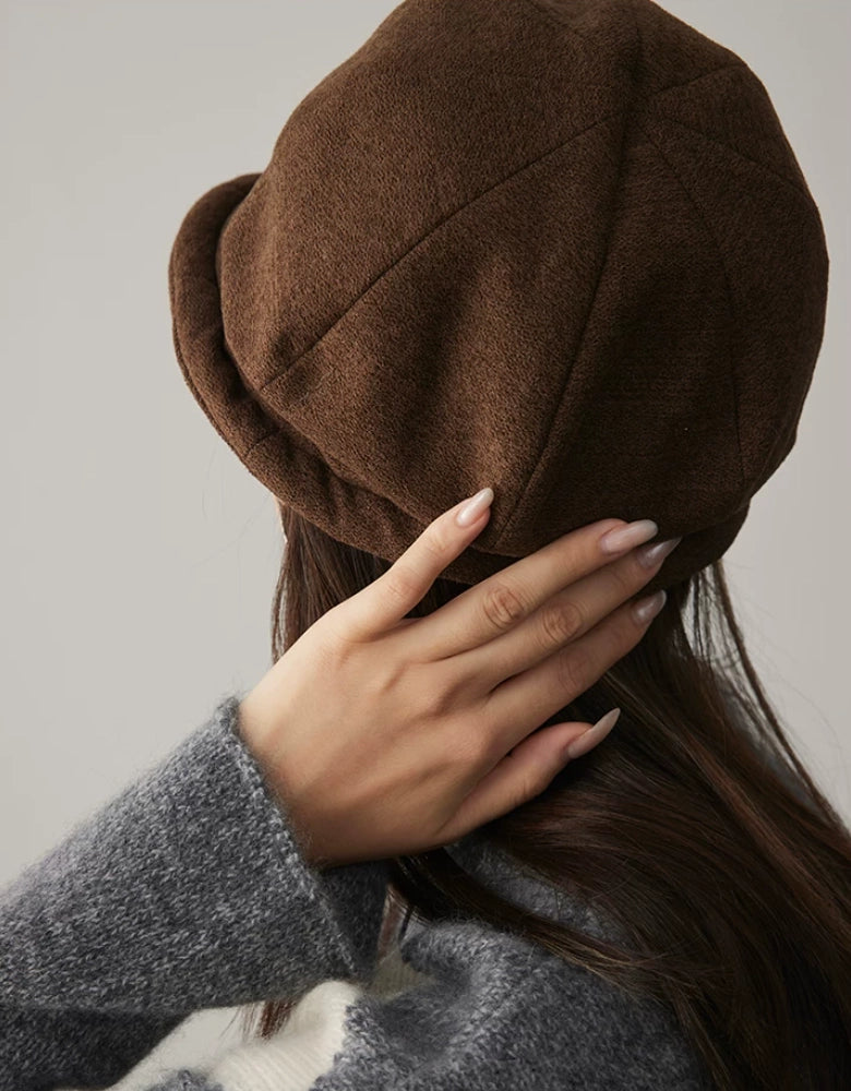 Close-up back view of a coffee brown felt dome hat with stitched panels and rolled brim