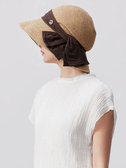 Coffee straw sun hat with wide brim, brown ribbon detail and breathable paper straw texture for elegant summer wear.