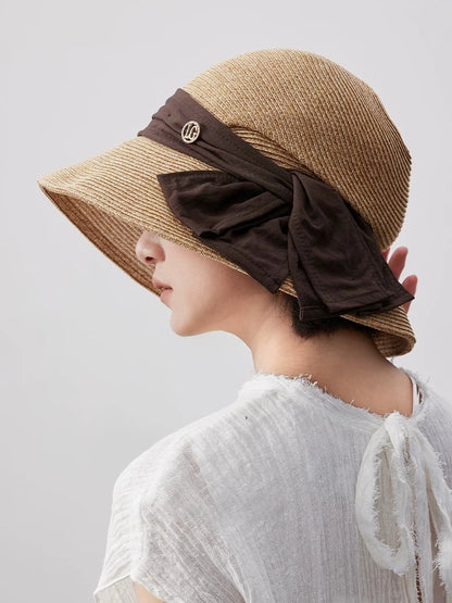 Coffee wide brim straw hat with brown bow ribbon and adjustable fit, shown from the back for elegant resort styling.